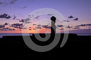 Ahu Tahai Moai Statue silhouette wearing topknot at sunset near Hanga Roa - Easter Island, Chile