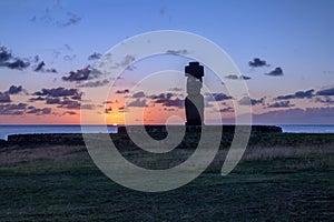 Ahu Tahai Moai Statue wearing topknot with eyes painted at sunset near Hanga Roa - Easter Island, Chile