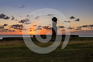 Ahu Tahai Moai Statue wearing topknot with eyes painted at sunset near Hanga Roa - Easter Island, Chile