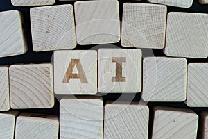AI, Artificial Intelligence or machine learning in future world concept, straggle cube wooden blocks with some combine the word AI photo