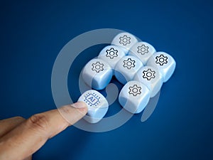 AI chip icon on white cube block push by hand to group of management symbol blocks, on blue background.