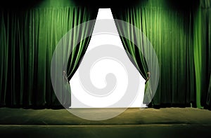 green velvet curtains draped on a empty stage. wood floor.