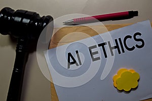 AI Ethics text on document above brown envelope and stethoscope. Healthcare or medical concept