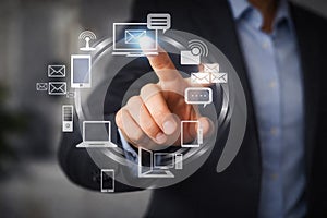 AI generated businessman touching digital communication interface with connected device icons representing data management cloud