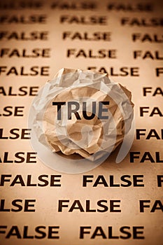 True And False Concept With Crumpled Paper Highlighting Truth Among Lies