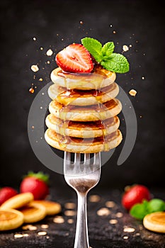 Mini Pancake Stack With Honey Strawberry And Mint On Fork