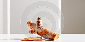 Fresh turmeric root with thin turmeric slices.