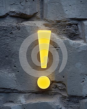 Glowing exclamation mark on stone wall background