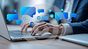 A person actively engaged in typing on a sleek silver laptop