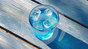 AI generated illustration of a glass of blue cocktail with ice cubes on a wooden table