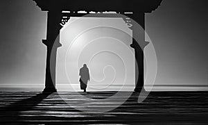 AI generated illustration of a silhouette of man walking through archway by ocean at twilight