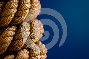 AI generated illustration of a sturdy rope made from tightly woven fibers on a blue background