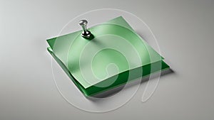 Green sticky note pinned to a surface with a pushpin