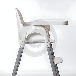 AI-Generated Image of White High Chair with Gray Legs and Tray photo