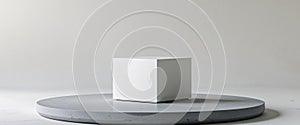Simple cube resting on a circular stone platform photo