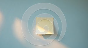 Sticky note of a pastel blue wall with copy space