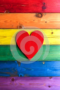 Red Heart On Rainbow Colored Wooden Background Representing Love And Inclusion