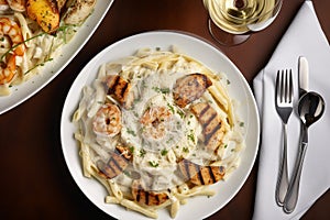 A plate of creamy fettuccine Alfredo with grilled shrimp and Parmesan cheese