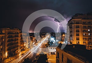 An AI illustration of lightning in the night sky above a city street with buildings