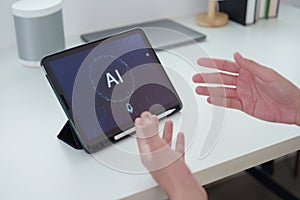 AI Interaction. User engaging with AI interface on tablet for smart solutions.