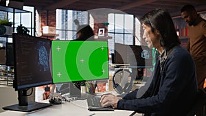 AI startup office senior developer building application on green screen computer