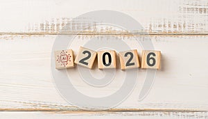 AI Technology Icon and Wooden Blocks Forming 2026 on Light Wooden Background Representing Artificial Intelligence Future