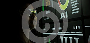 AI Using. Silhouetted analysts interact with a large AI data display