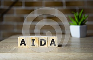 aida acronym of attention interest desire action business word on wooden cubes