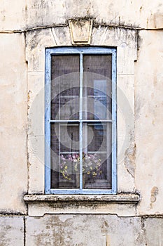 A blue framed window on an old building