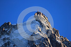 Aiguille du Midi in the evening sun, Mont Blanc massif, Chamonix-Mont-Blanc, French Alps, France.