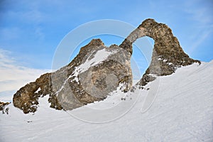 Aiguille Percee viewpoint in Winter, a popular rock formation with a hole in the middle in Tignes ski resort, France
