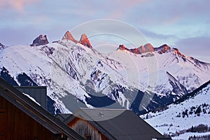 Aiguilles d Arves mountain peaks at sunset, in Les Sybelles ski resort, France, during the Winter holidays