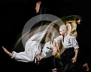 Aikido bodokas man and woman isolated black background