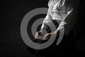 Aikido Hakama Sitting Pose Over Black photo