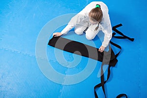 An aikidoka girl folding her hakama for Aikido