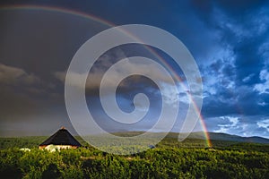 Ail the traditional altai house and tourist tents around under the rainbow