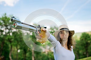 Aiming sport female shooter, detail on hand holding grip of 10 m