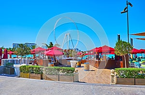 Ain Dubai ferris wheel behind the outdoor restaurant of JBR Marina Beach, Dubai, UAE