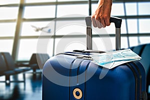 Air or airplane travel during pandemic concept with hand luggage and masks in an airport terminal