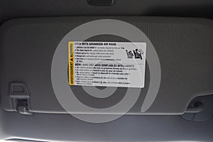 Air bag warning label on new vehicle visor warning of child placement
