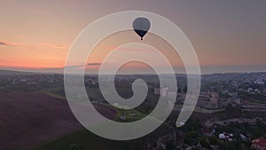 Air balloon flies over the Kamianets-Podilskyi Castle in Ukraine on sunset