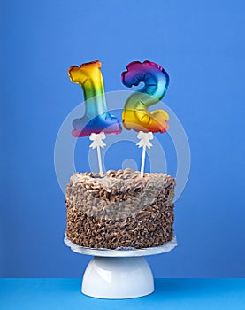 Air balloon number 12 - Birthday cake on blue background