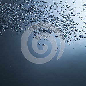 Air bubbles in blue water