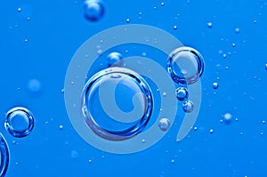 Air bubbles in blue water. Macro