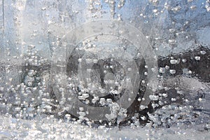 Air bubbles in the glass transparent immobile frozen from ice