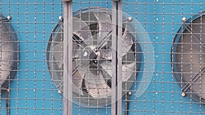 Air compressor unit for climate control system of industrial building with rotating ventilation fans for cooling