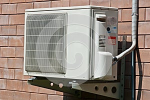 Air condition condenser unit hanging on wall