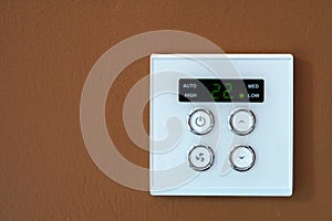 Air condition switch control on the brown wall