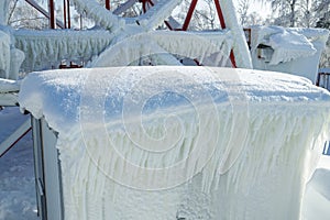 Air-conditioned container outdoors covered with ice and snow