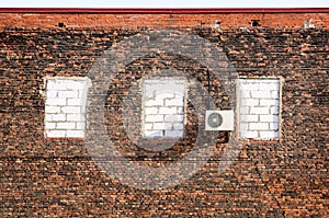 Air conditioner on a brick wall.